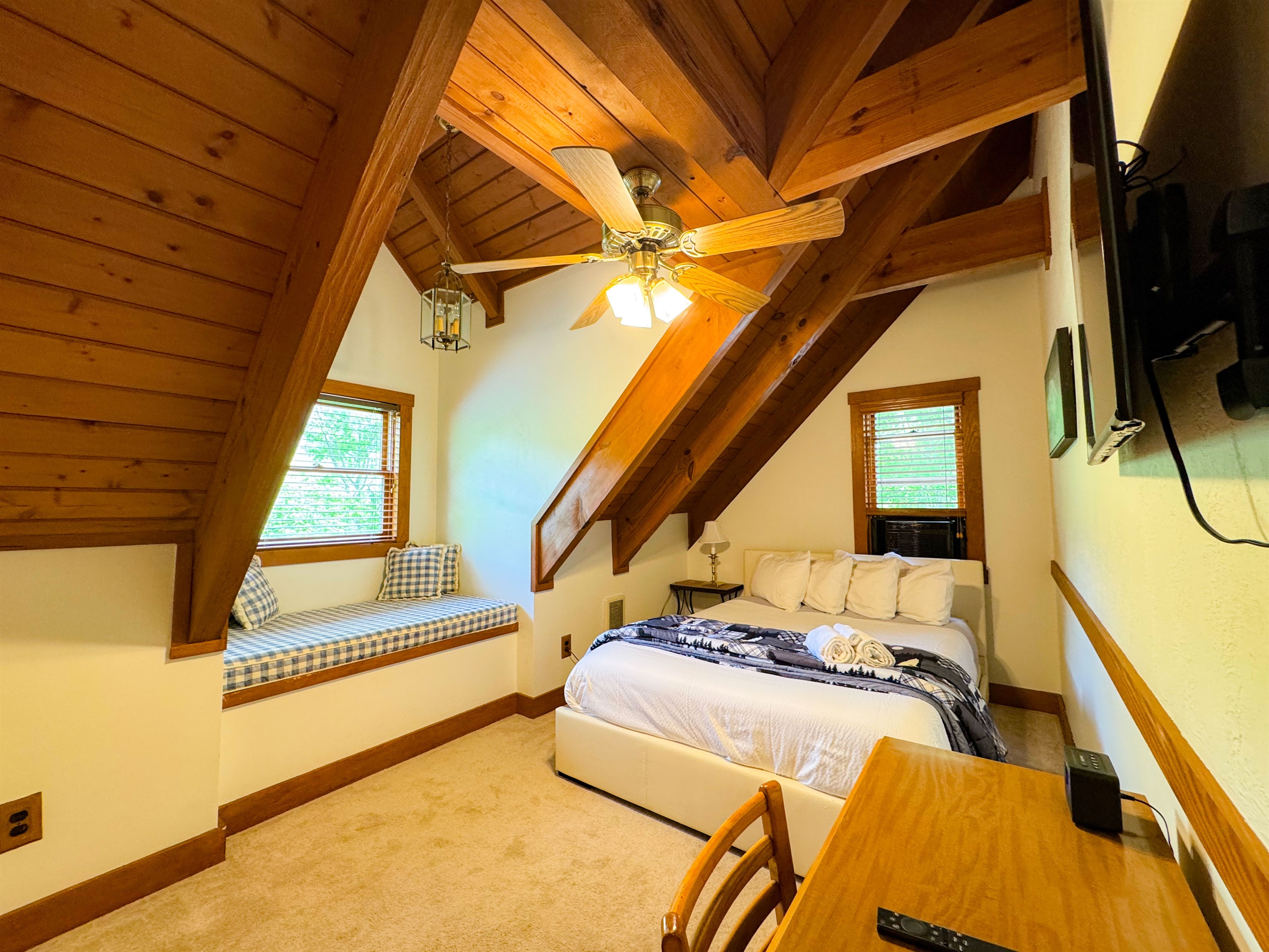 The upper level bedroom has a queen size bed and its own TV