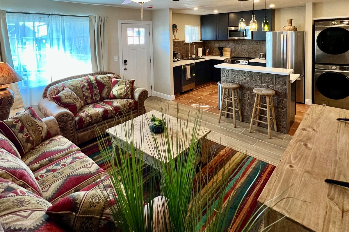 Relax in the spacious, open-concept living room, flowing right into a modern, fully-equipped kitchen. Perfect for gathering!