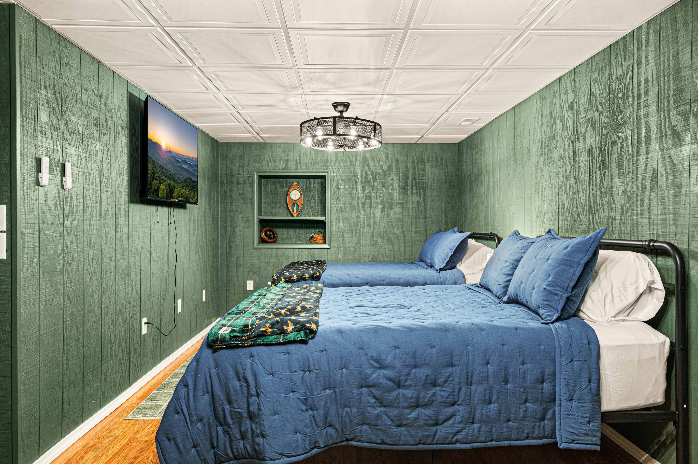 Bedroom Retreat: Enjoy restful nights in this charming room with twin beds and striking green decor!