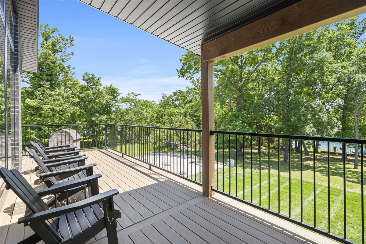 Upper deck with adirondack seating and composite picnic table. This is just off of the kitchen/dining space.