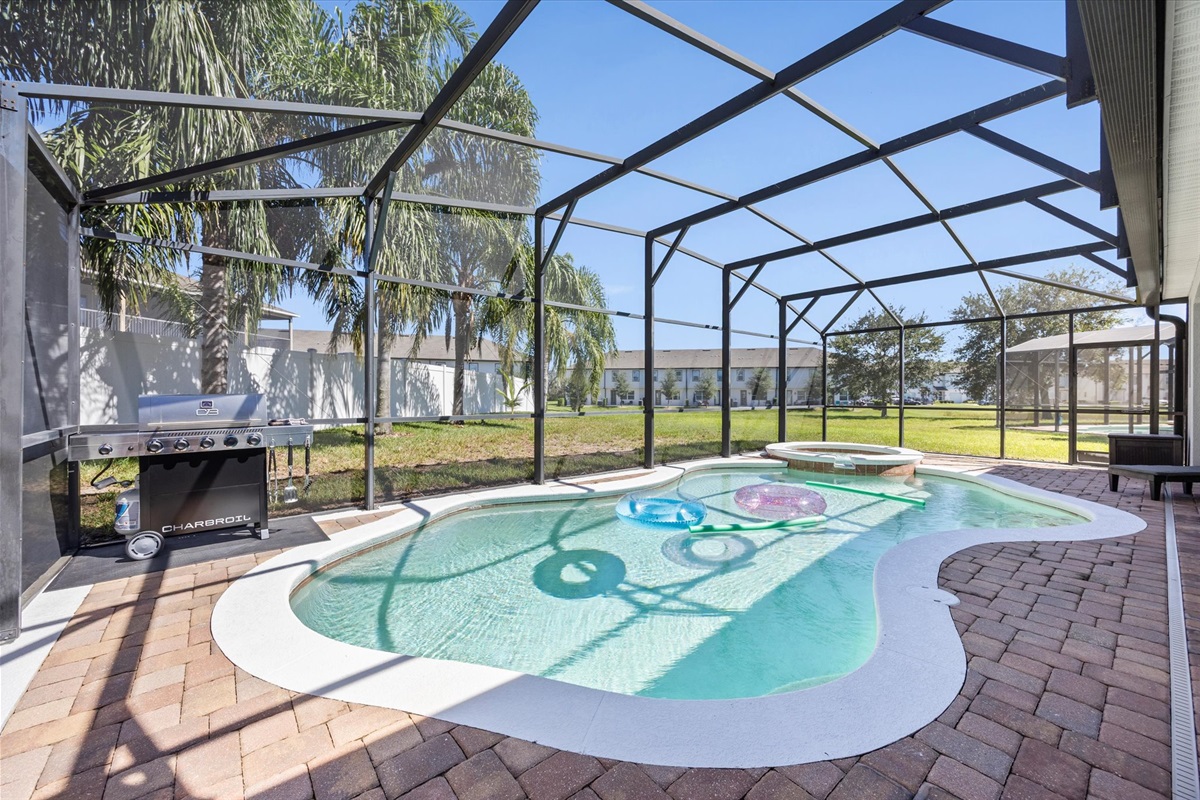 Soak up the Florida sunshine in your own screened-in oasis — featuring a sparkling pool, bubbling spa, and BBQ grill for the perfect day of relaxation and fun.