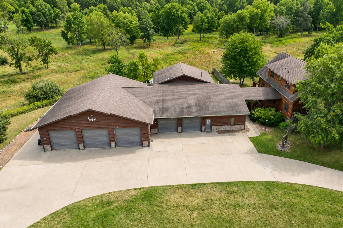 Aerial view shows the House, neighboring Lodge and shared parking areas so guests can clearly understand the property layout.
