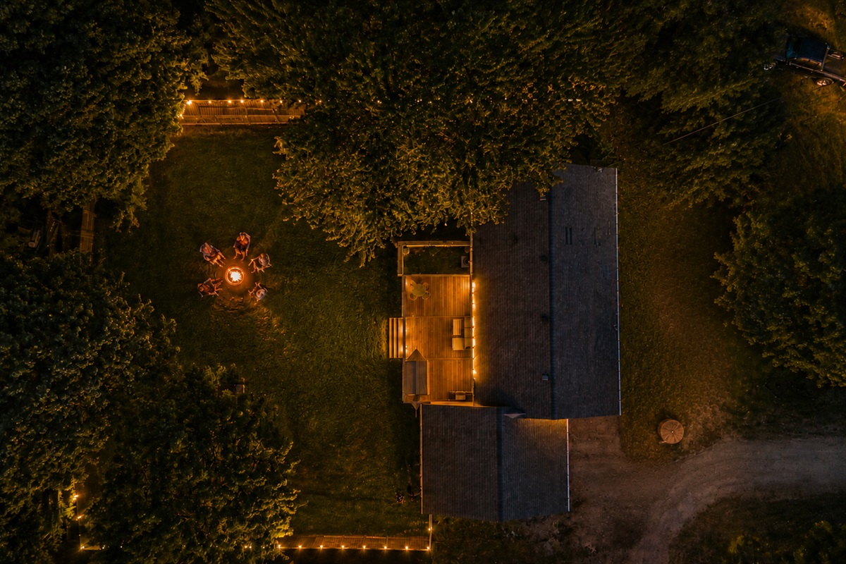 Crackling fires and room to unwind under the trees. This private backyard retreat is made for slow evenings, s’mores, and Northern Michigan memories.