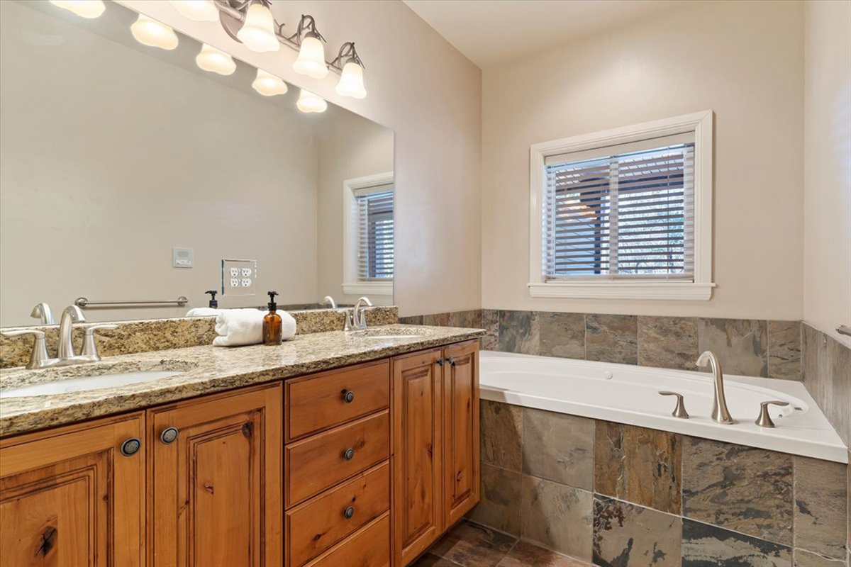 A spacious primary ensuite featuring dual vanities, a soaking tub, and elegant finishes—designed for a spa-like experience and relaxation.