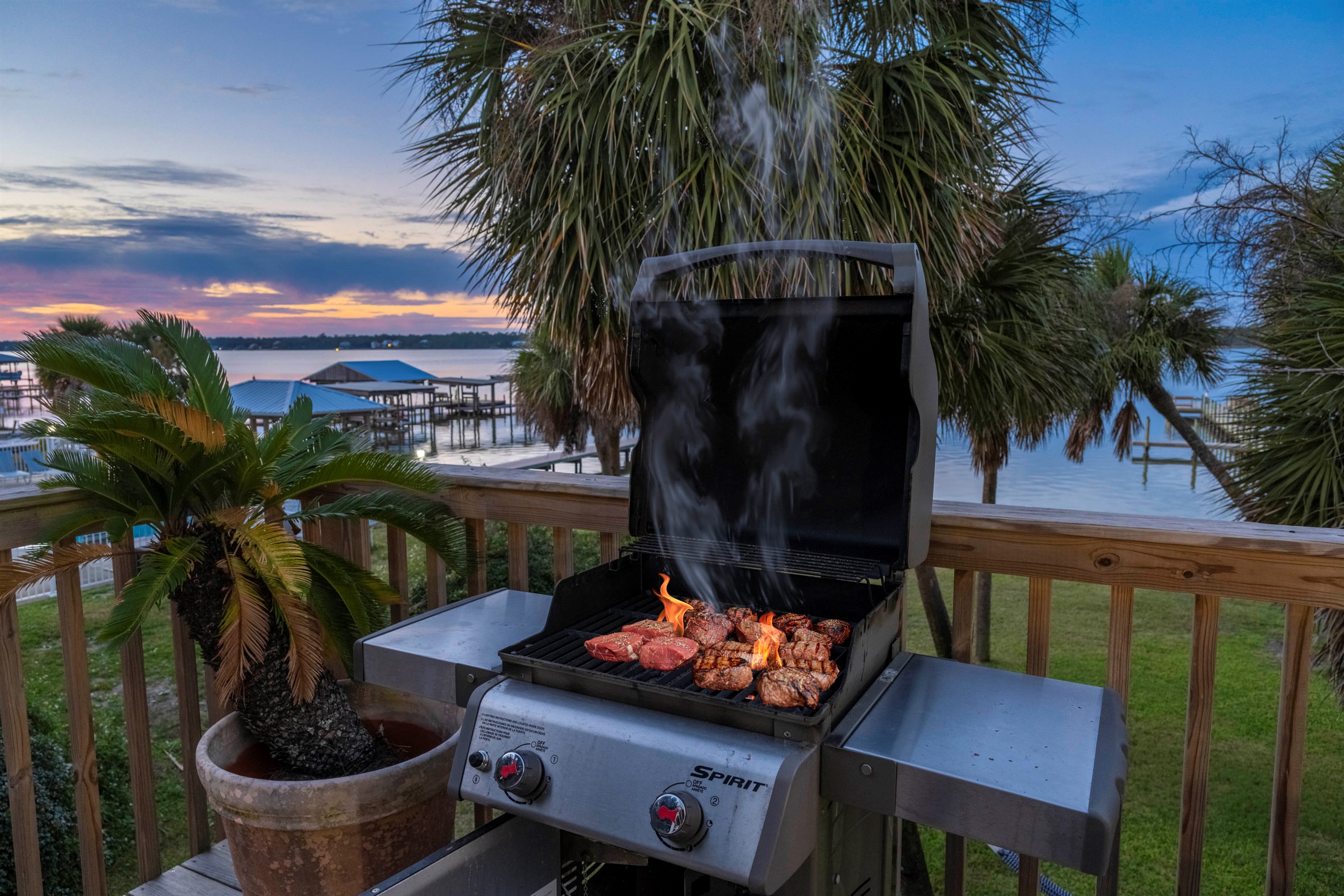 Sunset BBQ delight by the water with palm trees and a scenic outdoor vibe. Yes, this is your view while grilling on the patio.  