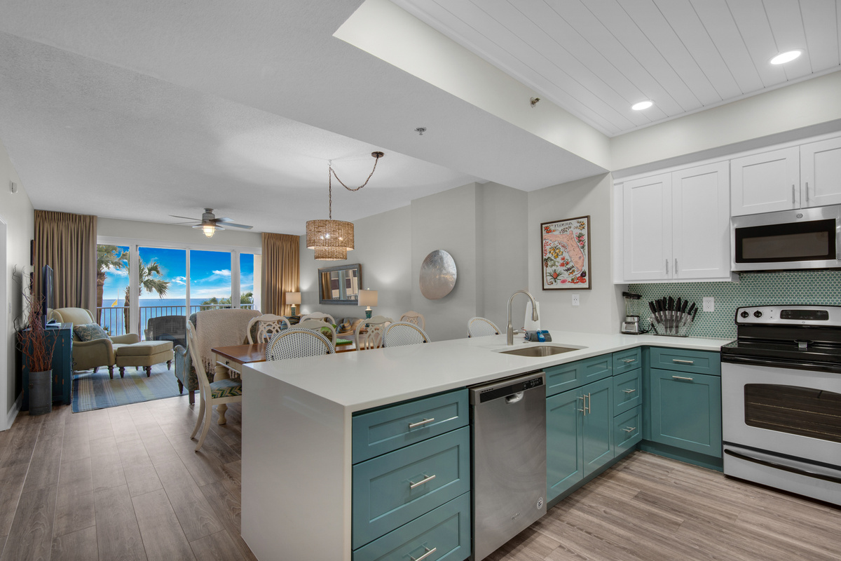 Open kitchen and living area with Gulf views and a TV. Living-room furniture shown has since been replaced.
