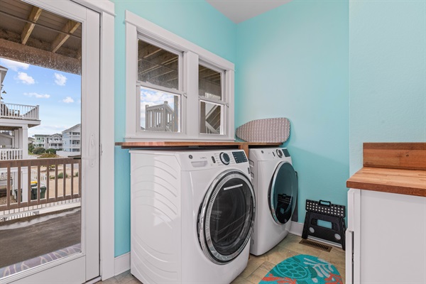 Laundry room on 2nd floor with deck overlooking backyard and access to stairs to 3rd floor and ground floor.