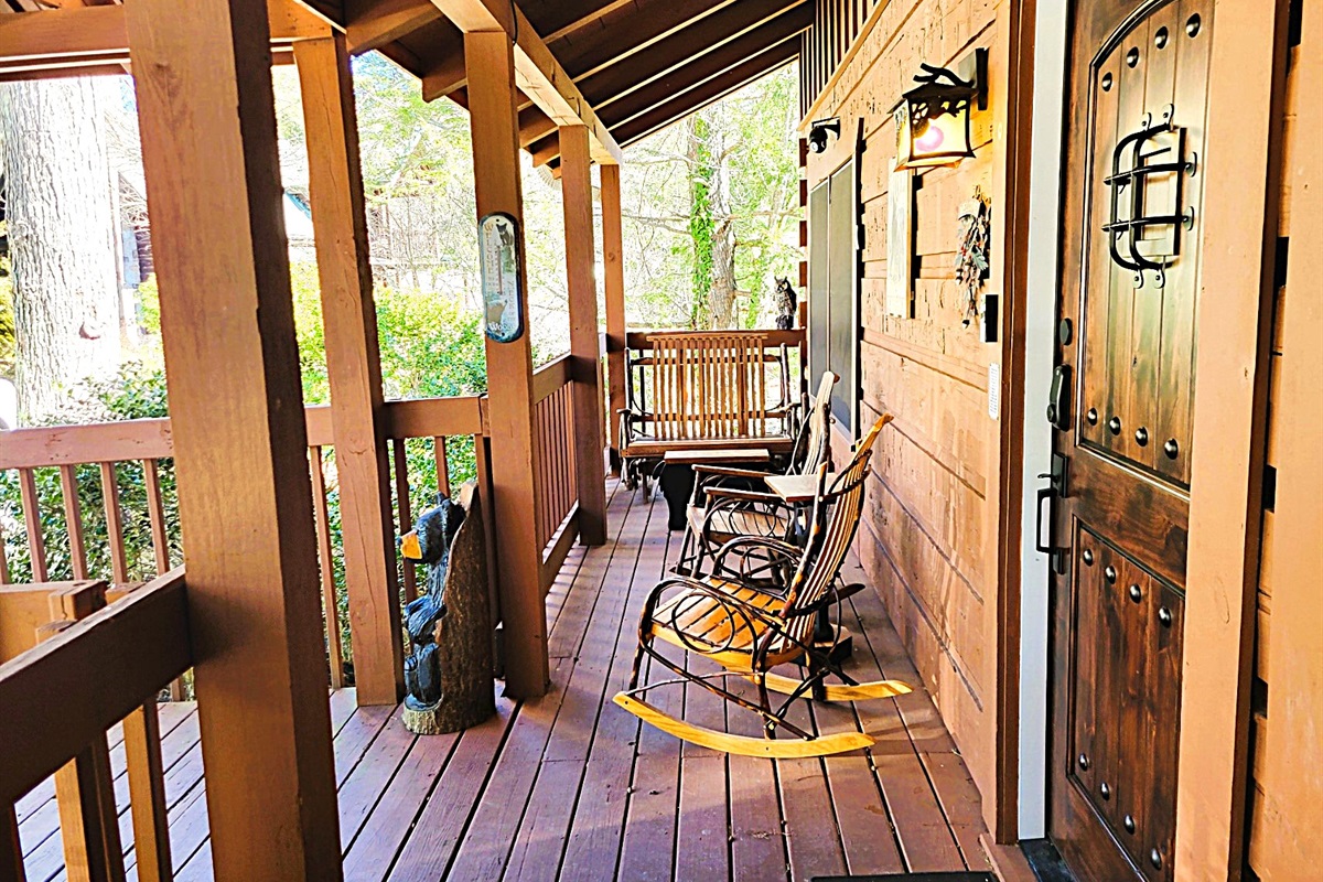Rocking chairs and double rocker on the front porch.