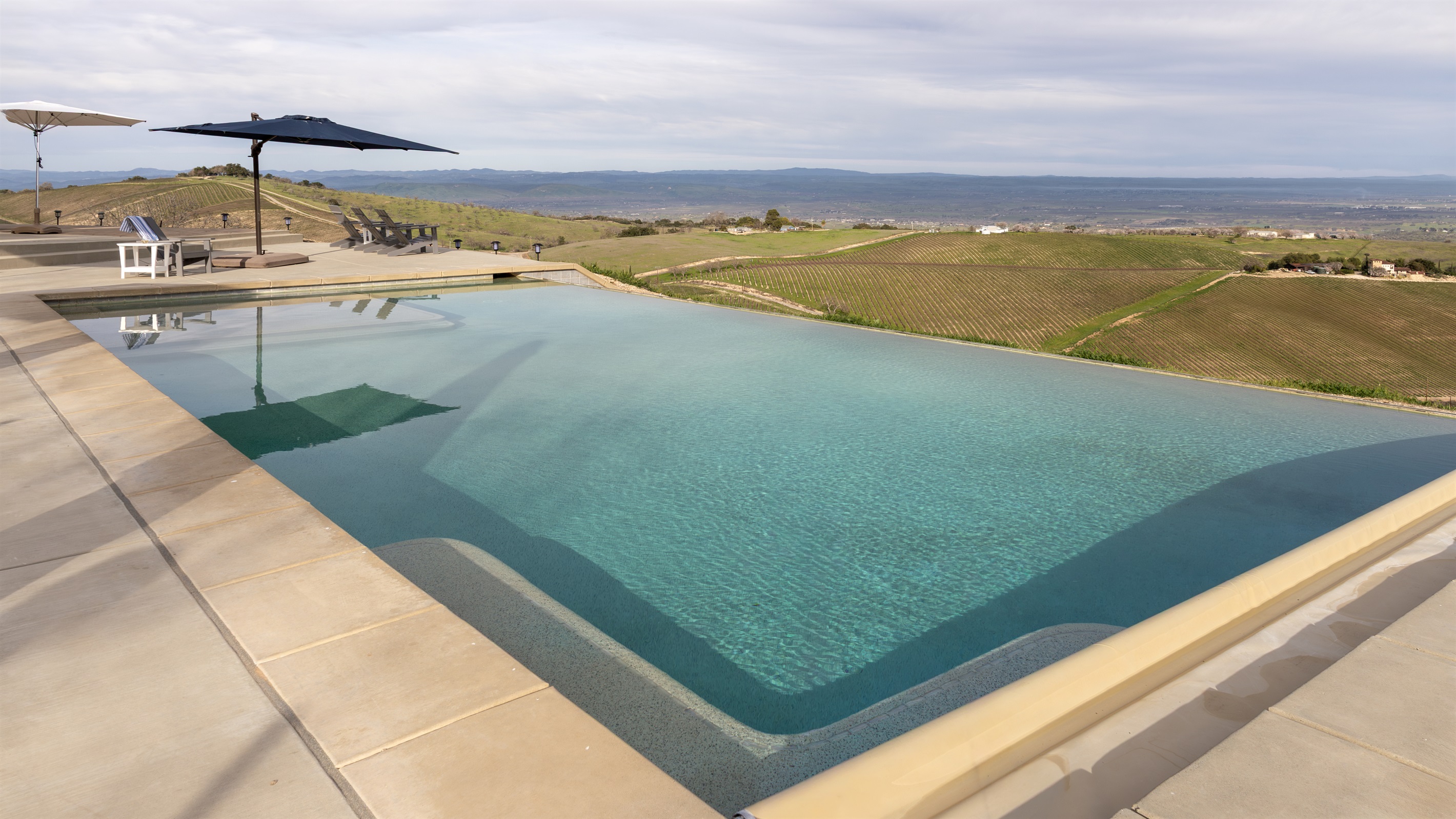 Crystal-clear water meets the edge of the hilltop, where the vineyards of the Adelaida District roll away into the distance. You'll have a hard time getting out.