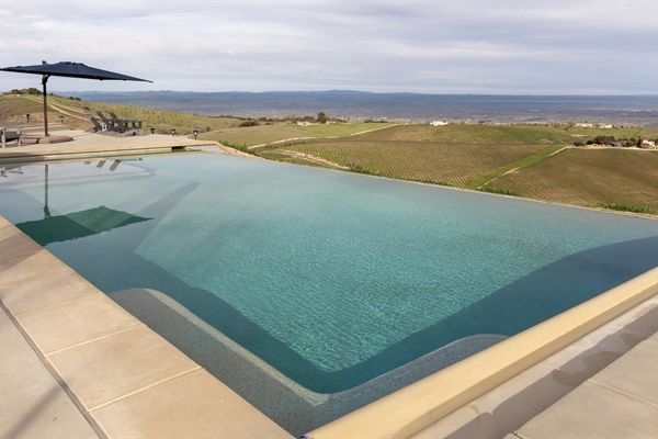 Crystal-clear water meets the edge of the hilltop, where the vineyards of the Adelaida District roll away into the distance. You'll have a hard time getting out.