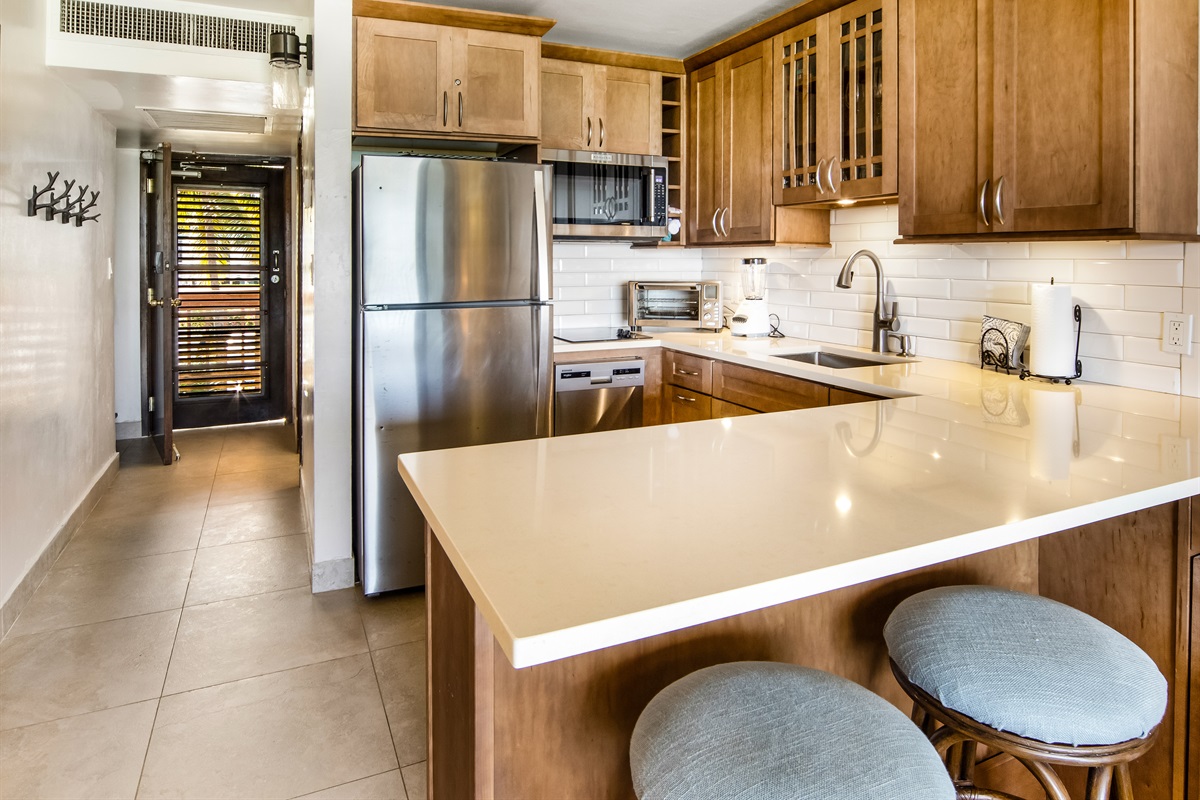 Modern kitchen with island seating, perfect for prepping meals or gathering with family and friends.