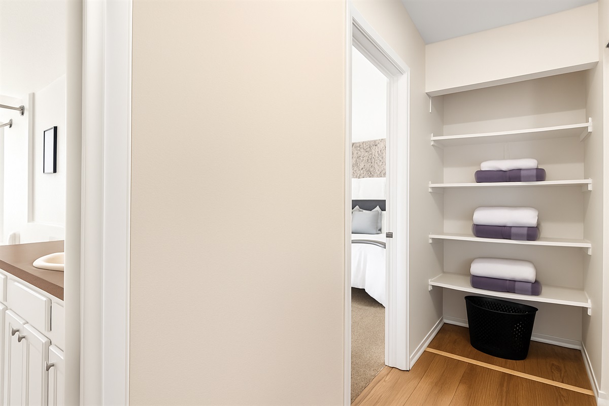 Spacious closet with shelving to keep your belongings organized during your stay.