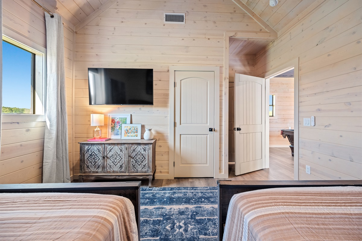 Bedroom 3 with double queens and wall-mounted TV.