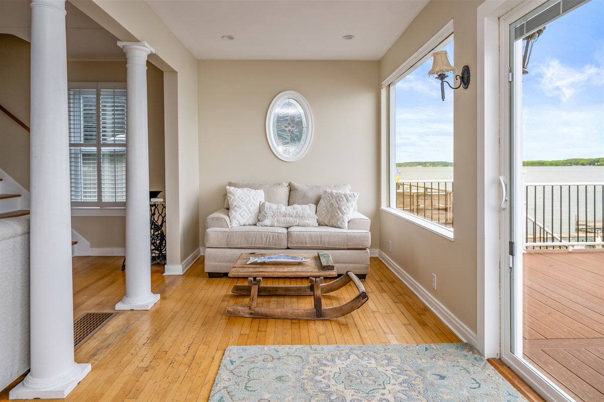 Relax in this serene sitting area with panoramic lake views and direct access to the deck 🛋️🌊☀️