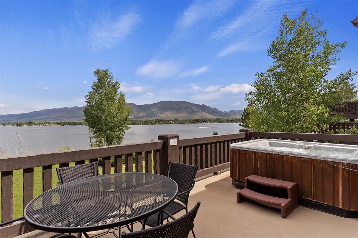 Private deck with breathtaking lake and mountain views with a hot tub—your front-row seat to sunrise coffee and sunset relaxation.