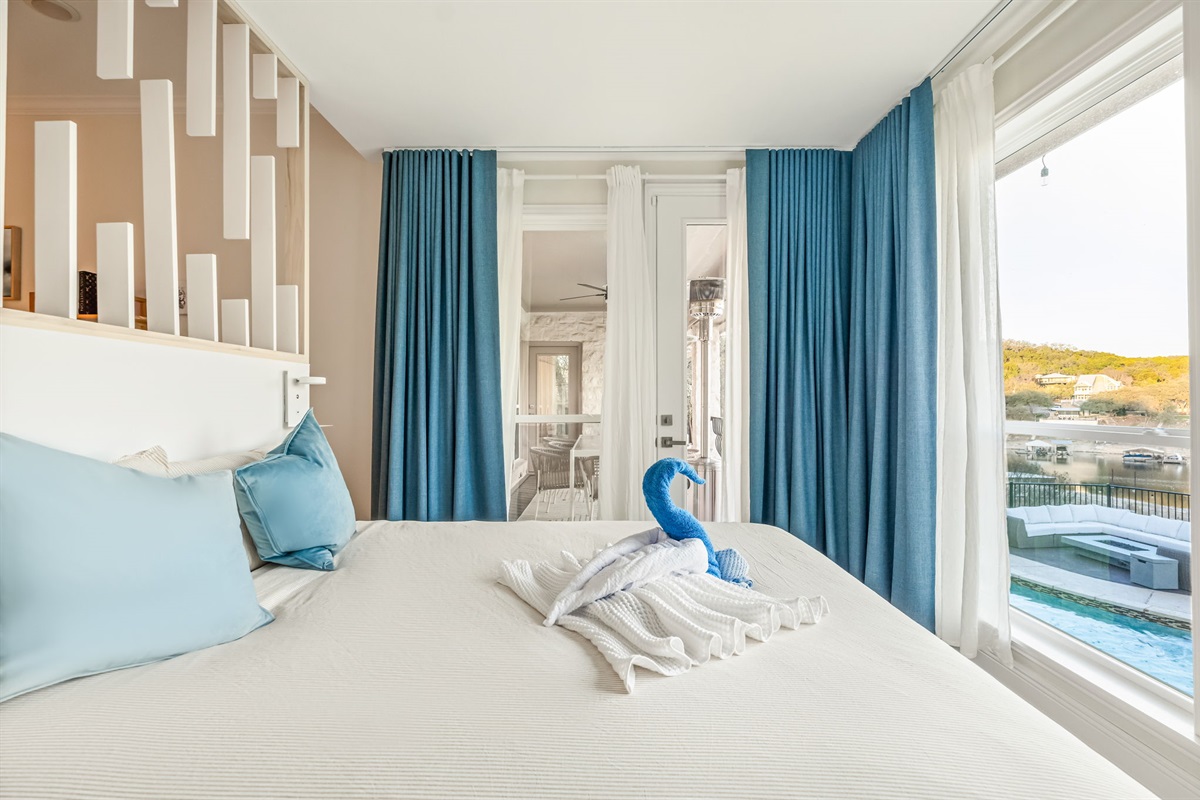 Serene lakeview bedroom with soft linens and beautiful morning light.