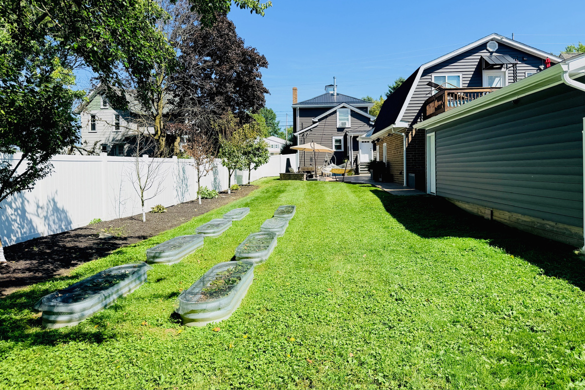 Fenced backyard with plenty of open lawn for play or relaxation.
