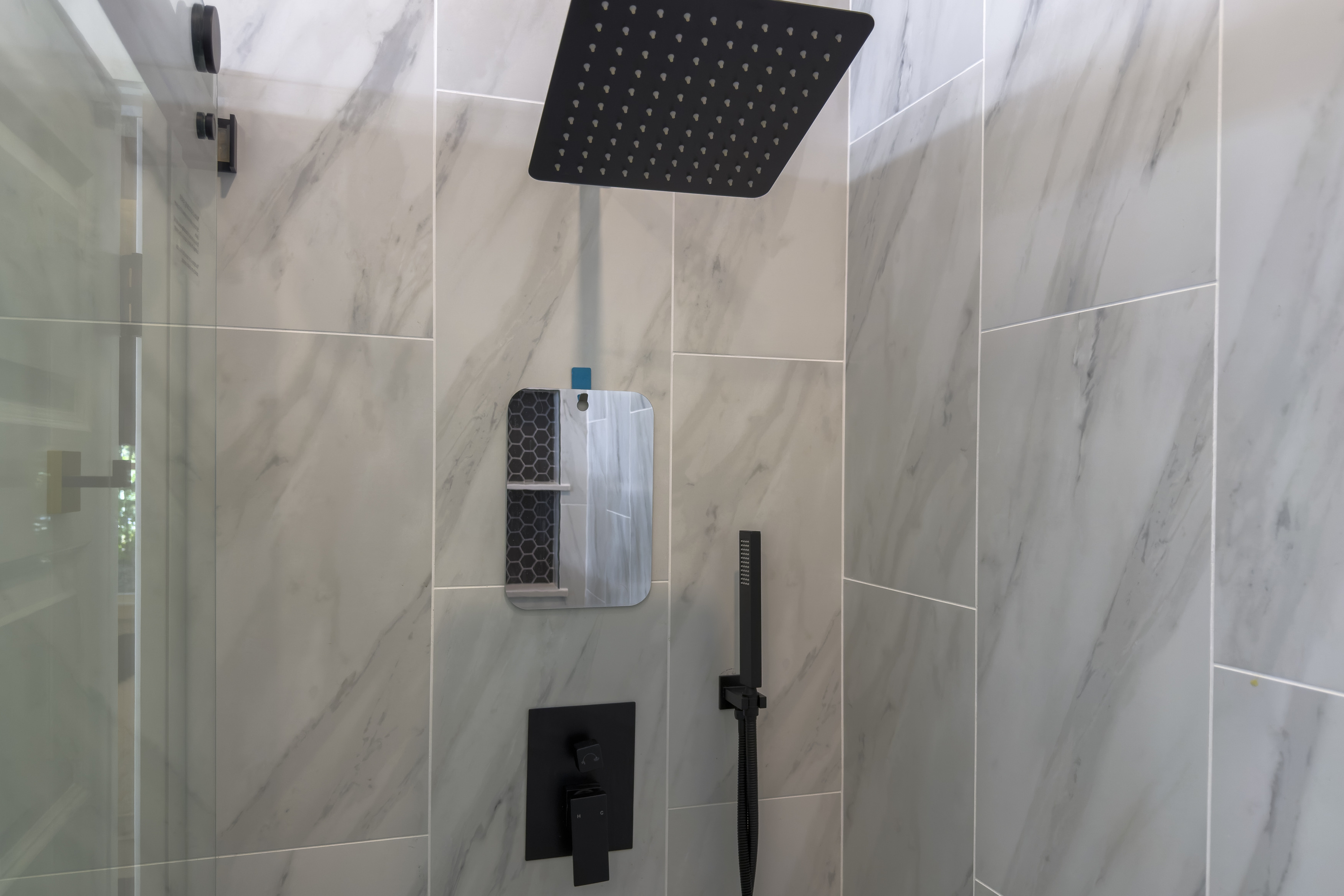 A little everyday luxury: the primary suite’s rainfall showerhead makes winding down part of the getaway.
