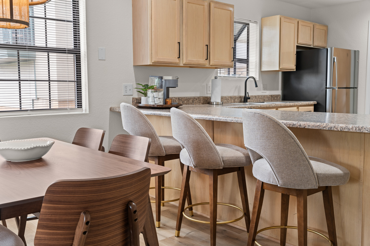 The dining table seats six, while the adjacent breakfast bar adds seating for three.