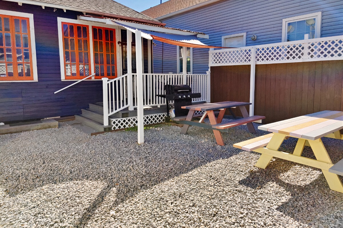 Rear fenced in private courtyard. Shaded propane grill, roofed porch w swinging bench. Off street parking not pictured.
