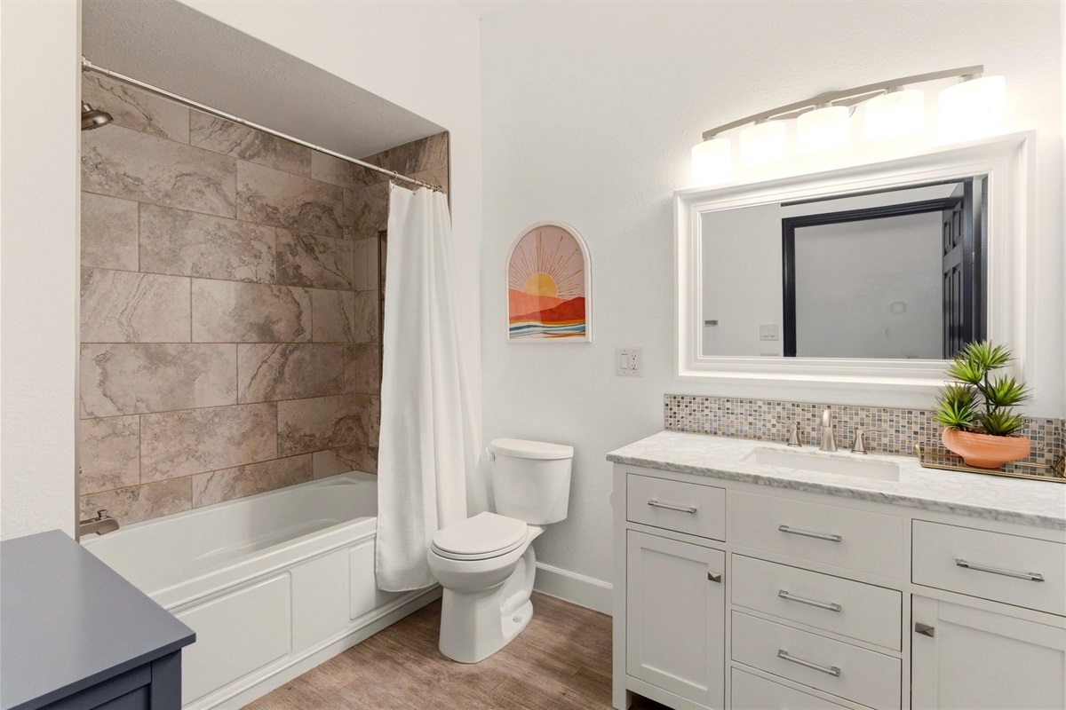 Middle Hallway Shared Bath NOW with toilet and shower grab bars.  83 in Turn Radius.  34 in Door Opening