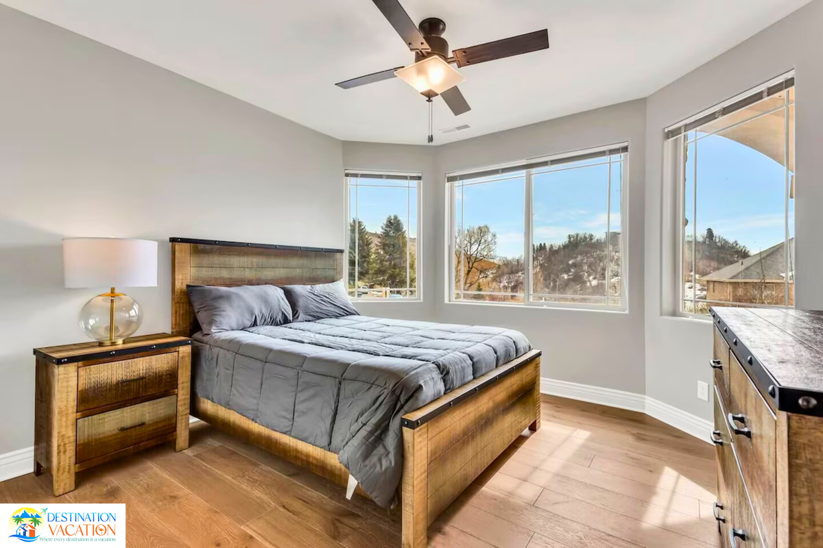 Serene bedroom framed by beautiful mountain views.