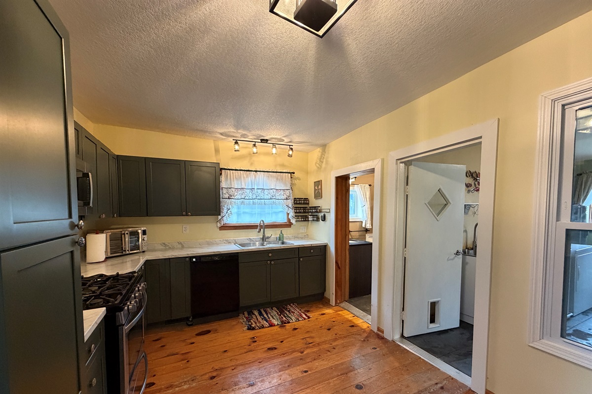 The kitchen leads to both the bathroom, laundry and dining room.
