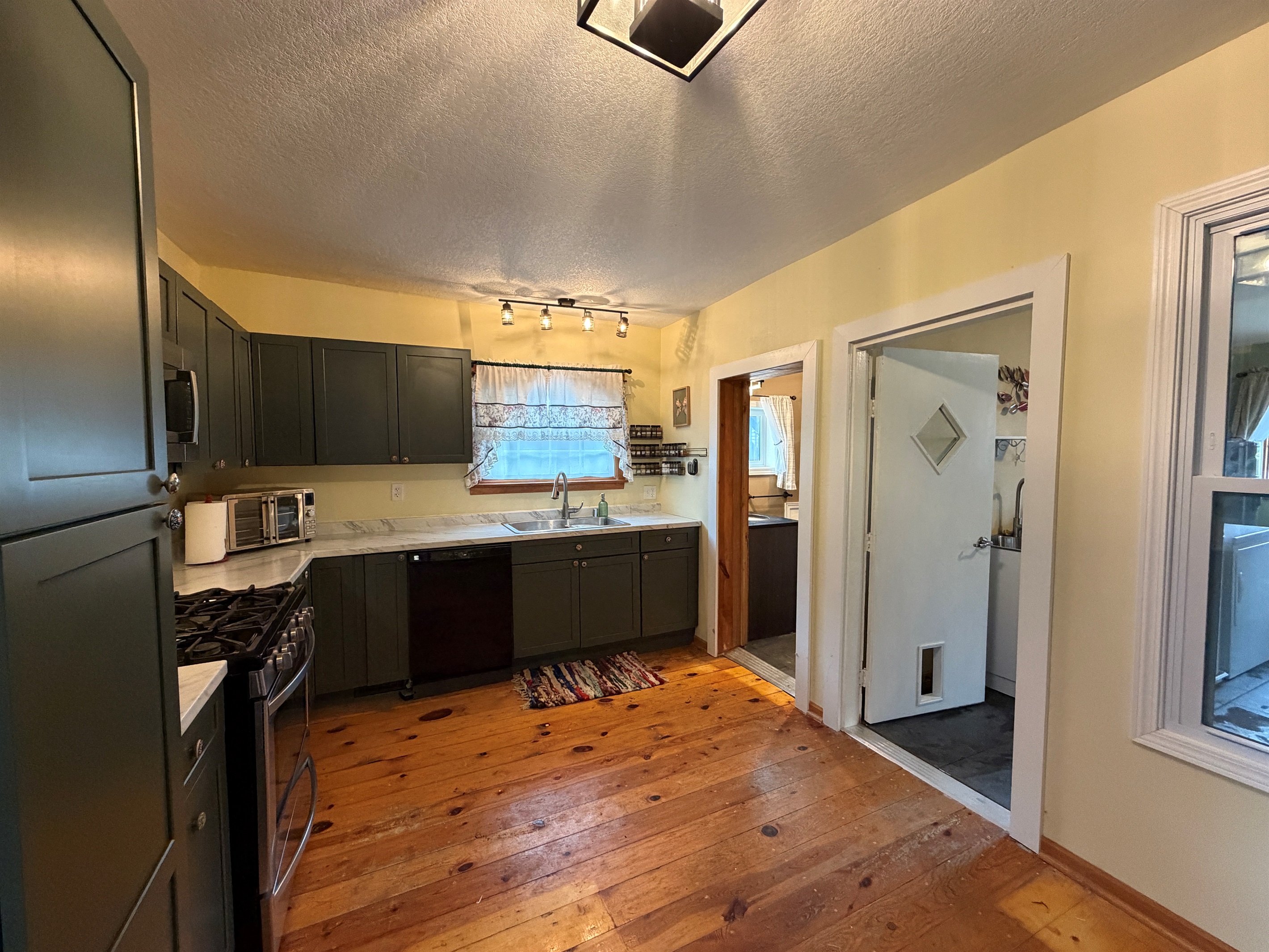 The kitchen leads to both the bathroom, laundry and dining room.