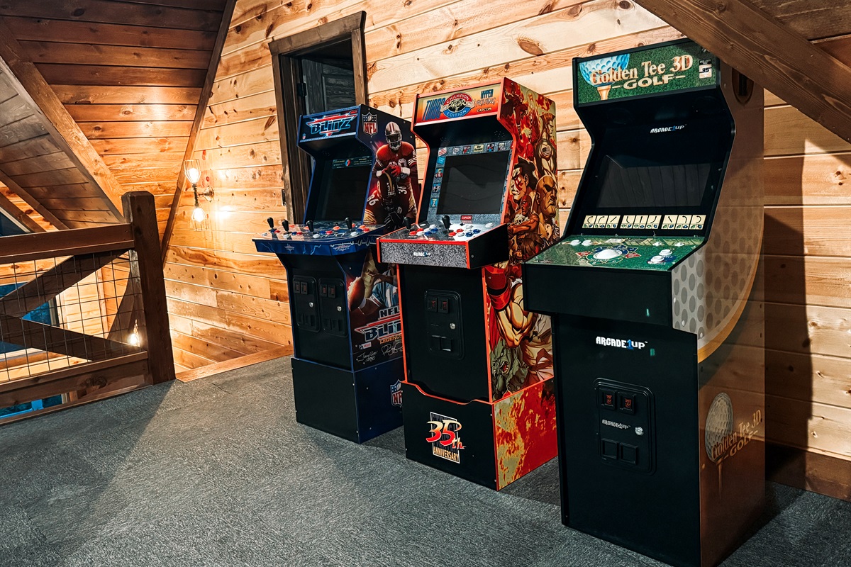 Level up family fun in the loft game room with 5 arcade machines and foosball.