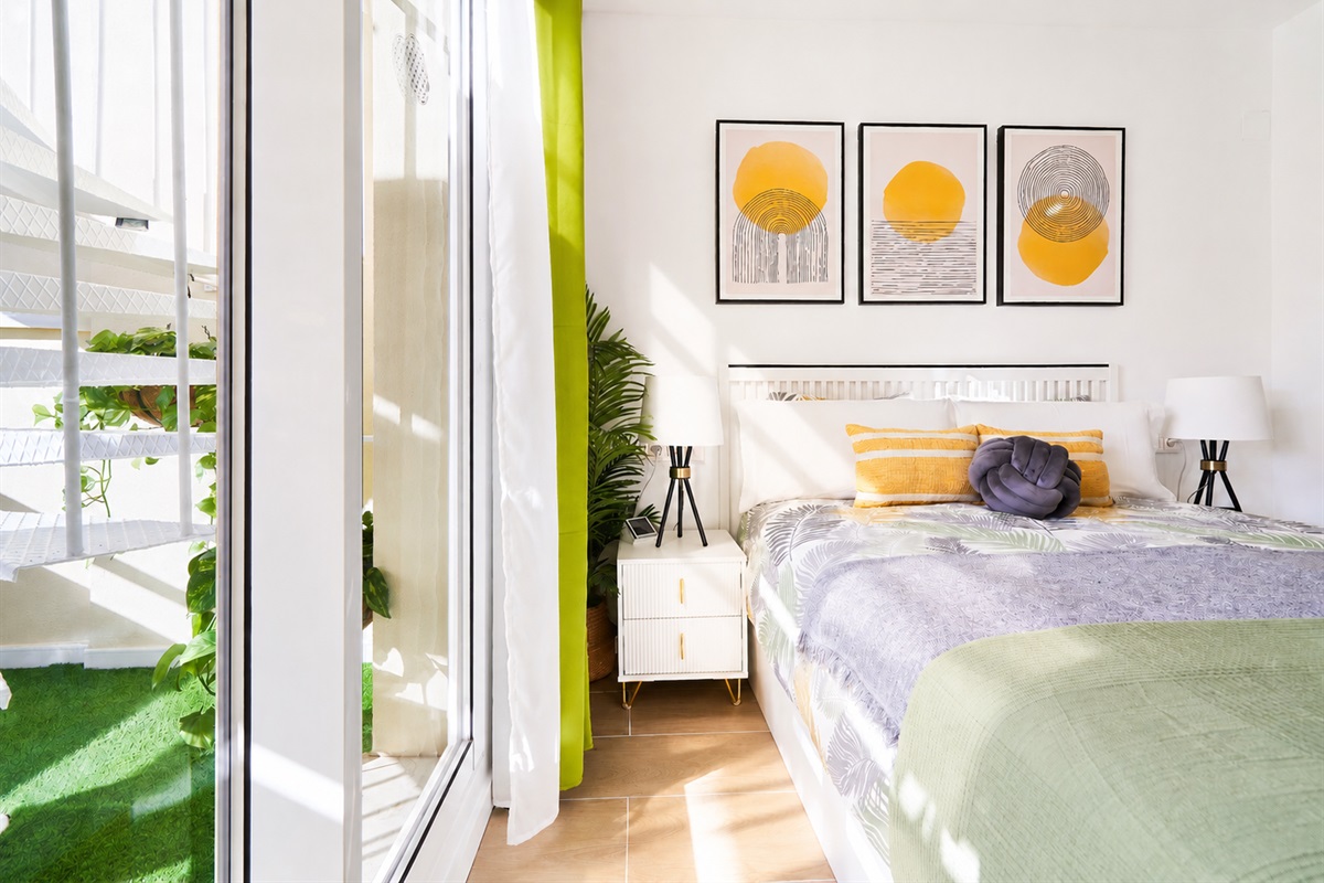 Bright and elegant master bedroom with a private terrace, walk-in wardrobe, and a serene atmosphere designed for restful nights.