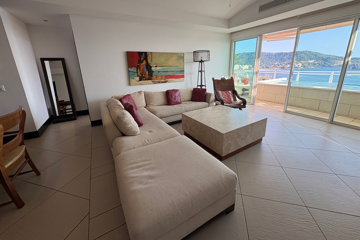 Living room seating with entrance to bedroom, and to the patio