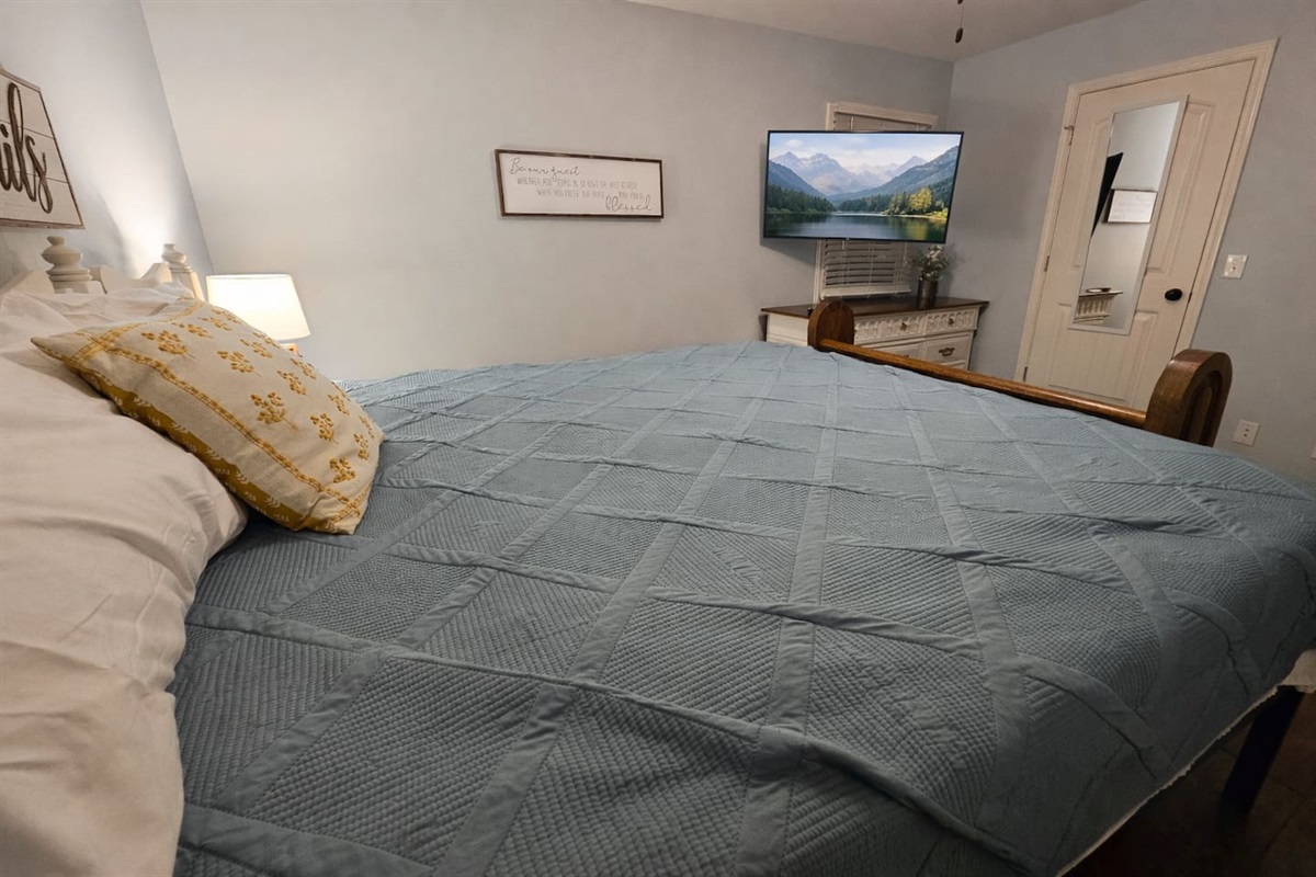 Master bedroom featuring a king bed and a 55-inch smart TV. BYOL