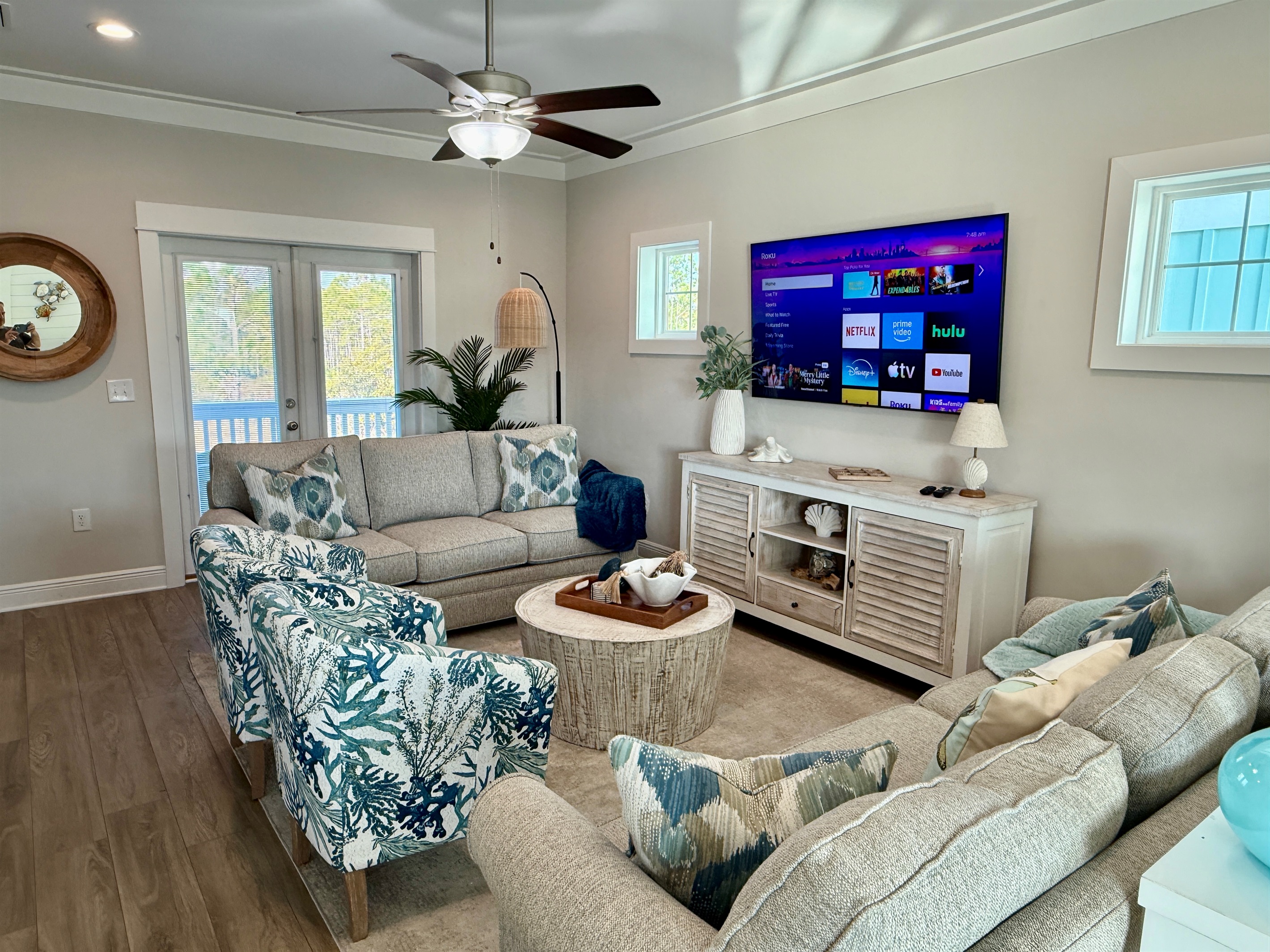 The whole family can enjoy the show together.  With two large, comfortable sofas and two additional barrel chairs, there is plenty of seating around the 75” Roku enabled Samsung TV. 