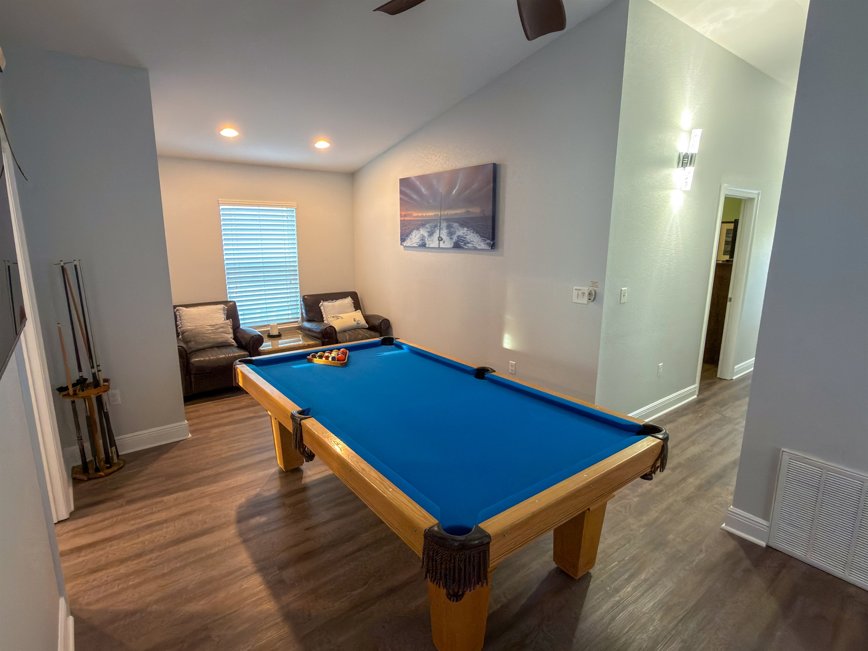 This upstairs lounge combines classic game-room fun with a cozy seating nook, ideal for watching the action or taking a quiet break.