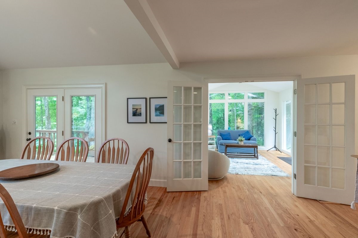 Dining Room: Enjoy meals with nature's backdrop through large glass doors and warm wooden charm!


