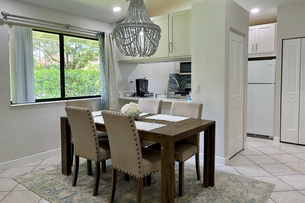 The dining area is right off the kitchen with seating for five, with a convenient bar area located by the window.