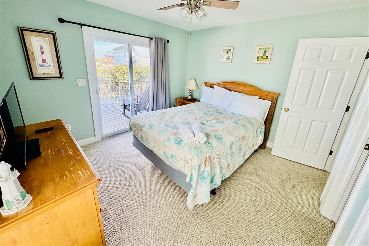 Cozy Queen bedroom with Smart TV and sliding door to deck.