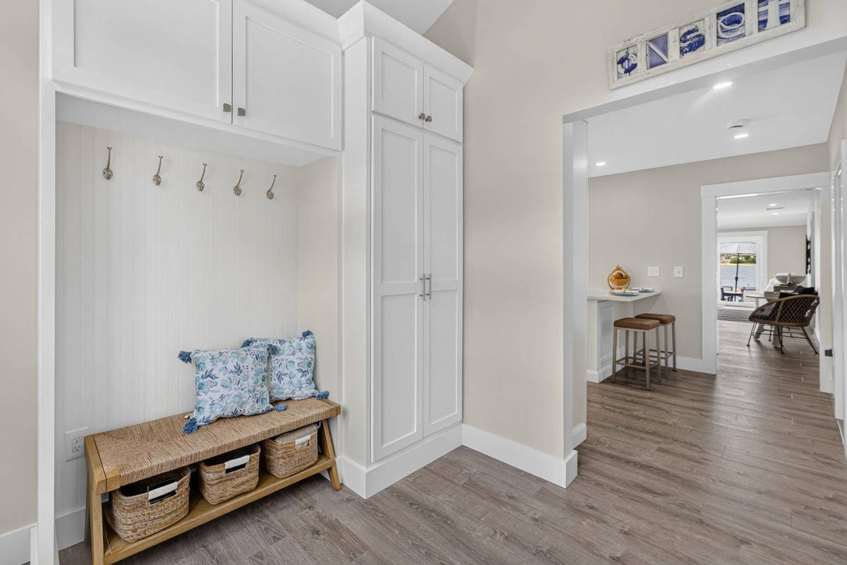 Welcoming entryway with convenient bench seating and hooks for coats, shoes, and everyday essentials.