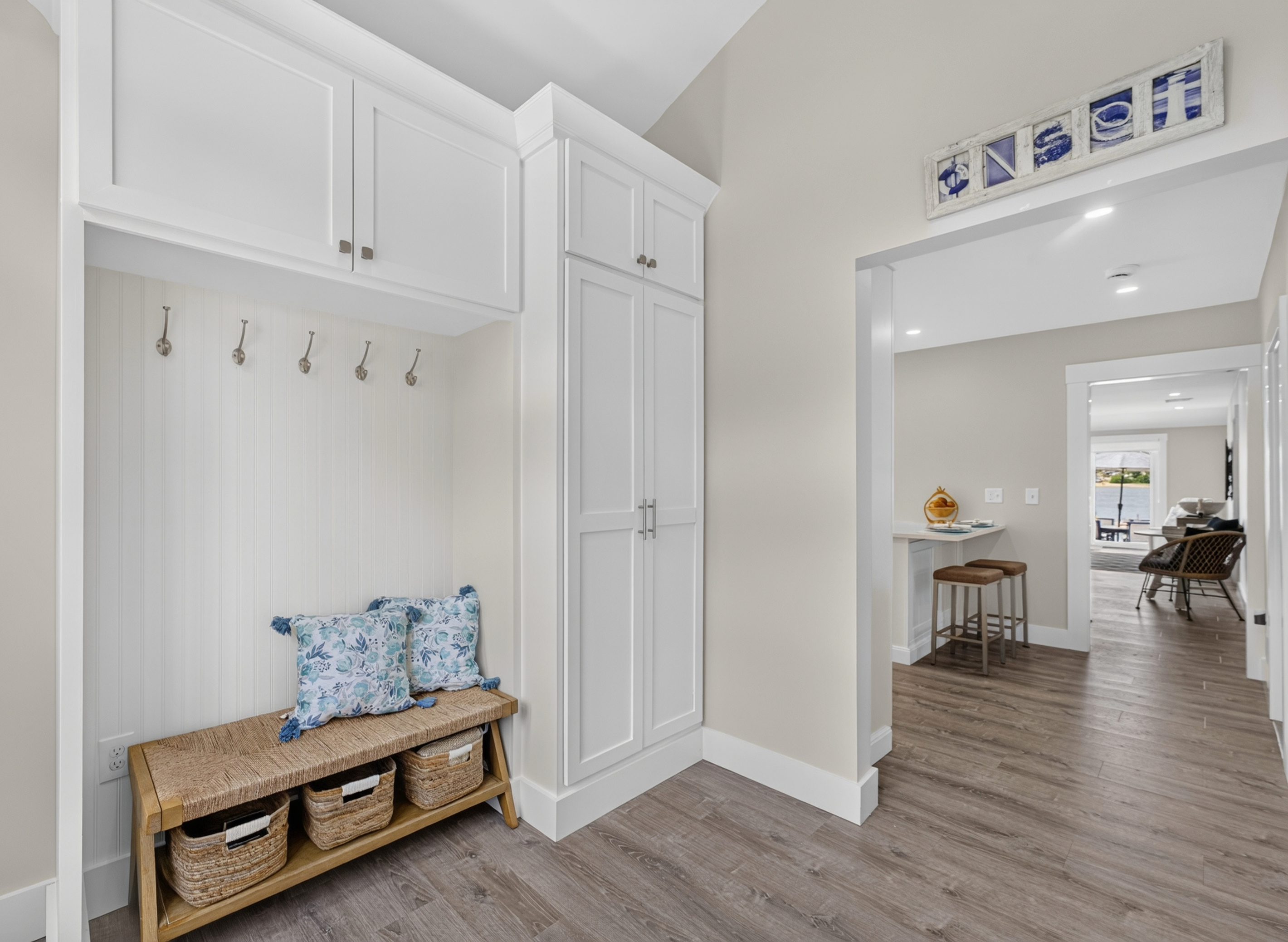 Welcoming entryway with convenient bench seating and hooks for coats, shoes, and everyday essentials.