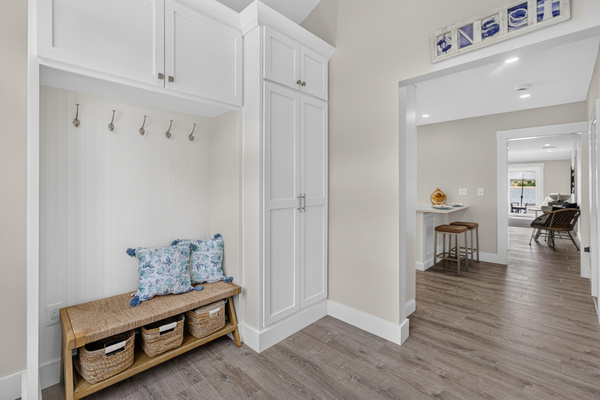 Welcoming entryway with convenient bench seating and hooks for coats, shoes, and everyday essentials.