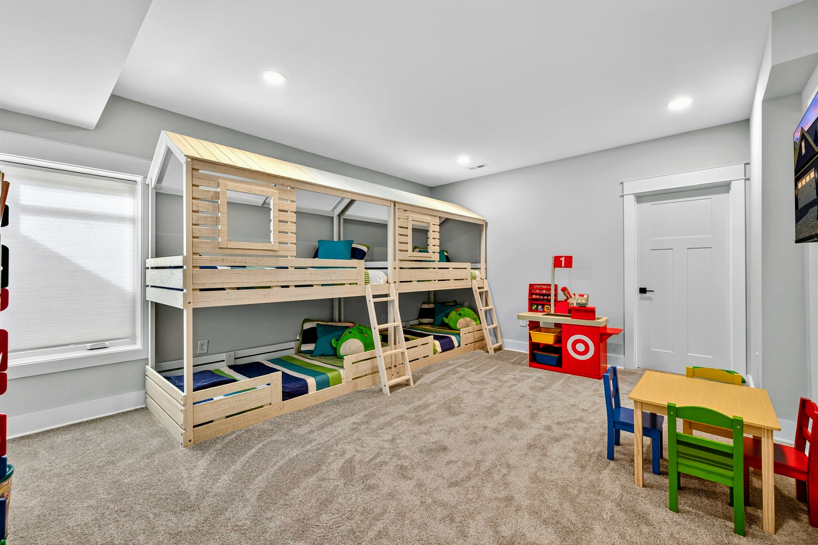 This charming quad bunk room features, crisp white bunks with bright colorful quilts, a play kitchen, Legos, books and toys make it a kids paradise! A built-in play-house coming Winter 2025 will add even more fun to this cheerful imaginative retreat.