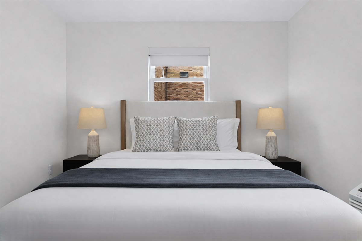 Settle into this peaceful bedroom with a comfortable bed, soft linens, warm bedside lighting, and a calm, minimalist design for restful nights.