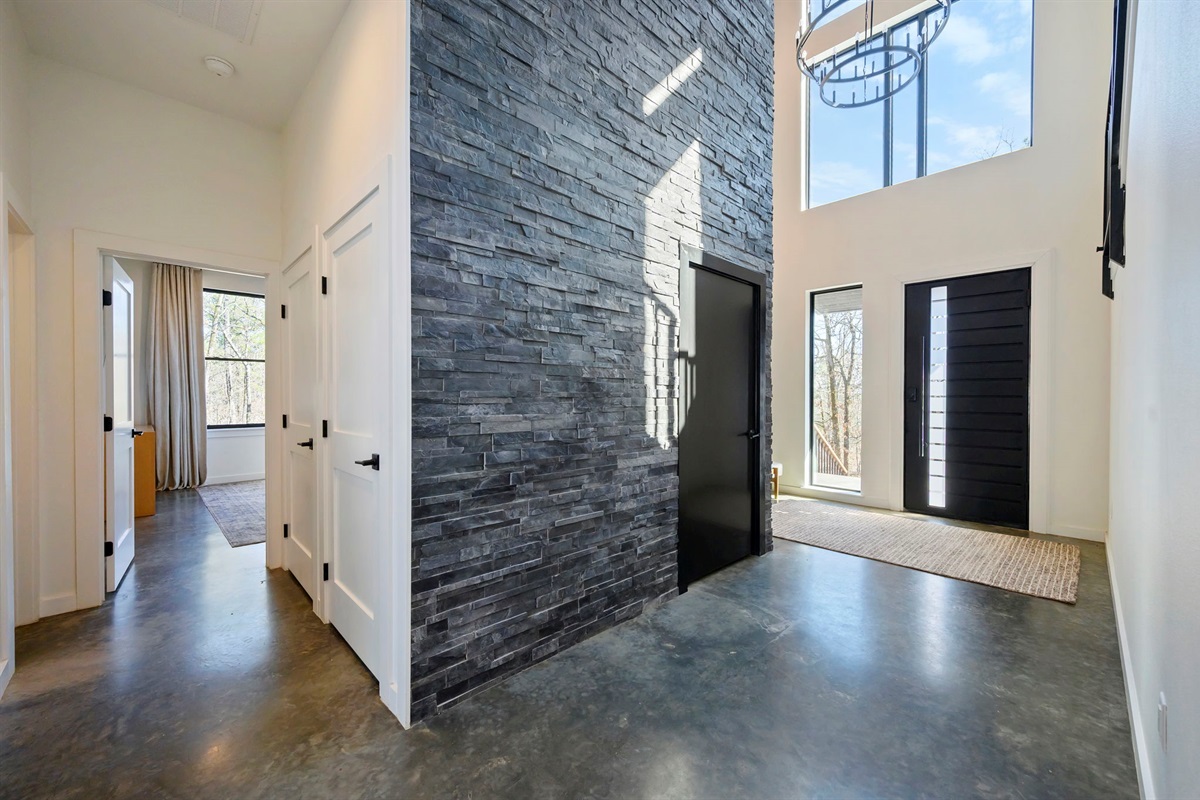 Main entrance to cabin, featuring a towering marble accent wall.