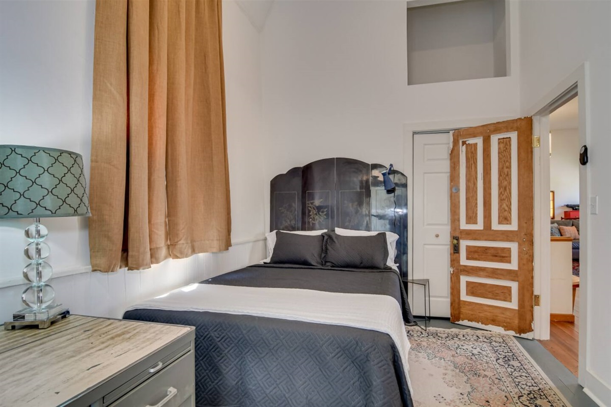 Spacious bedroom with modern black bedding.