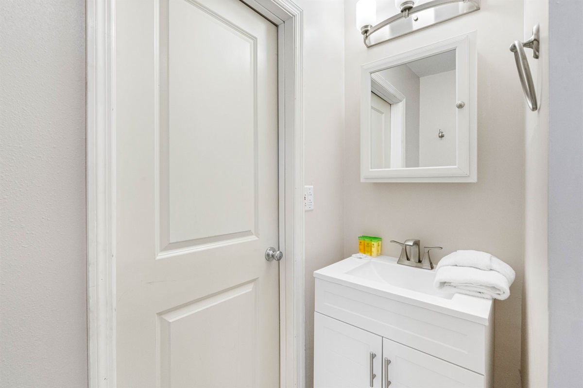 The standout feature is the generously sized walk-in shower, finished in rich natural stone tiles with a textured pebble-style floor.