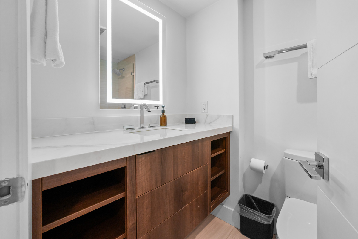 Modern full bathroom featuring a large vanity and plenty of storage space.