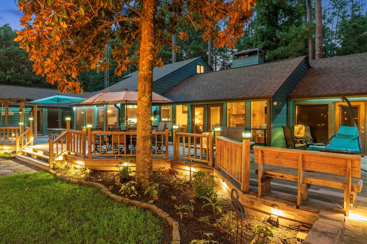 Back deck - connected to the house, offers large dining tables, bar seating, and swing seating for ultimate relaxation. Equipped with Bluetooth speakers, it’s the perfect spot for dining and hanging out.