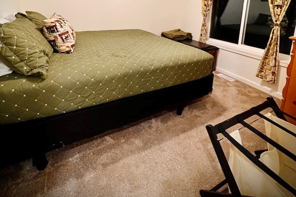 Home in the Woods, located upstairs, has a view of the lake and a king bed for 2.