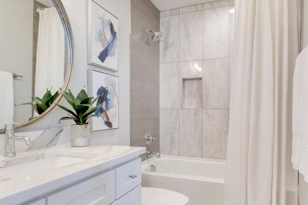 - Refresh in a sleek, spa like bathroom with a deep soaking tub and elegant chrome fixtures - Modern tile surround and niche shelving add style and convenience to your routine - Bright, airy vibes with luxe accents and a clean, polished vanity