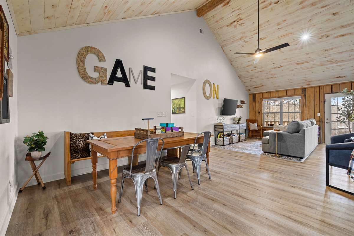 Back living room features game table + seating area.